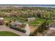 Expansive property featuring a main house, additional building, and large yard with views of the lake at 8280 Queen St, Arvada, CO 80005
