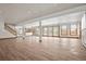 Finished basement boasting wood laminate flooring, recessed lights, and many windows at 8280 Queen St, Arvada, CO 80005