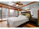 Bedroom features a ceiling fan, skylight, sliding glass doors to balcony and side tables at 8280 Queen St, Arvada, CO 80005