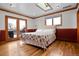 Bedroom with French doors leading to deck, skylight, hardwood floors and designer trim at 8280 Queen St, Arvada, CO 80005