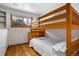Bedroom with wood floors and bunk beds and window looking outside at 8280 Queen St, Arvada, CO 80005