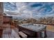Wood deck featuring built-in hot tub, wood pergola and mountain views at 8280 Queen St, Arvada, CO 80005