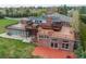 Exterior of the home showcasing a large deck, brick facade, and multiple windows for ample natural light at 8280 Queen St, Arvada, CO 80005