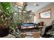 Indoor hot tub surrounded by lush plants and a serene rock garden for a spa-like experience at 8280 Queen St, Arvada, CO 80005