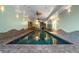 Large indoor pool with decorative wall designs, and ceiling fans at 8280 Queen St, Arvada, CO 80005