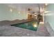 Indoor pool with fans, decorative walls, and stairs at 8280 Queen St, Arvada, CO 80005