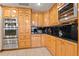 Gourmet kitchen features stainless steel appliances, sleek black granite countertops, and light wood cabinetry at 8280 Queen St, Arvada, CO 80005
