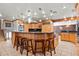 Spacious kitchen island with granite countertops, wood cabinets, seating, and modern stainless steel appliances at 8280 Queen St, Arvada, CO 80005