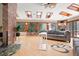 Sunlit living room with skylights, large windows overlooking the wooded landscape, and comfortable seating at 8280 Queen St, Arvada, CO 80005