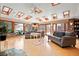 Bright and airy living room features skylights, large windows, and cozy seating arrangement with nature views at 8280 Queen St, Arvada, CO 80005