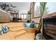 Cozy living room featuring a sunken seating area, fireplace, and large windows at 8280 Queen St, Arvada, CO 80005