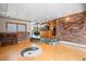 Open concept living area with hardwood floors, elevated kitchen space, and brick wall accents at 8280 Queen St, Arvada, CO 80005