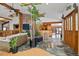 Open living space with wood beam ceilings, brick accents, and indoor plants, creating a nature-filled ambiance at 8280 Queen St, Arvada, CO 80005