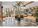 Spacious living room filled with natural light, stylish furnishings, and numerous plants at 8280 Queen St, Arvada, CO 80005