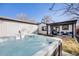 The backyard features a modern hot tub, lush green lawn and a cozy outdoor patio area at 2645 Jasmine St, Denver, CO 80207