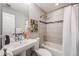 Bright bathroom featuring a shower over bath and a white vanity and toilet at 2645 Jasmine St, Denver, CO 80207