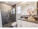 Bathroom with stylish glass shower, dark stone floors and modern white vanity at 2645 Jasmine St, Denver, CO 80207