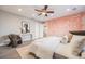 Bedroom with a statement wall, ceiling fan and white modern furniture at 2645 Jasmine St, Denver, CO 80207