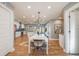 Open-concept dining area with hardwood floors, modern lighting, and access to the kitchen at 2645 Jasmine St, Denver, CO 80207