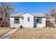 Charming, renovated bungalow featuring stucco siding, modern windows, and a well-maintained front yard at 2645 Jasmine St, Denver, CO 80207