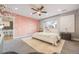 Bright main bedroom featuring a modern ceiling fan, stylish accent wall, and natural light at 2645 Jasmine St, Denver, CO 80207