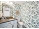 Charming powder room featuring blue floral wallpaper, modern fixtures, and ample space at 2645 Jasmine St, Denver, CO 80207