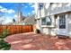 Large brick patio with a wood fence, offering an ideal outdoor space for entertaining at 2246 Mountain Sage Dr, Highlands Ranch, CO 80126