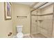 Tiled bathroom with a glass-enclosed shower, toilet, and sleek towel rack at 2246 Mountain Sage Dr, Highlands Ranch, CO 80126