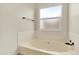 Bathroom featuring soaking tub with tile surround and window with privacy glass at 2246 Mountain Sage Dr, Highlands Ranch, CO 80126