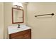 Bathroom vanity featuring modern fixtures, a wood cabinet, and a rectangular mirror at 2246 Mountain Sage Dr, Highlands Ranch, CO 80126