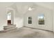 Vaulted ceiling in an empty bedroom with neutral carpet and paint, features two windows with a view, and stairway to another level at 2246 Mountain Sage Dr, Highlands Ranch, CO 80126