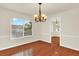 Dining room featuring gleaming hardwood floors, large windows, traditional chandelier, and generous square footage at 2246 Mountain Sage Dr, Highlands Ranch, CO 80126