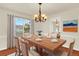 Formal dining room featuring a large wooden table with seating for six, a chandelier, and natural light at 2246 Mountain Sage Dr, Highlands Ranch, CO 80126