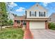 Charming two-story home with brick accents, a well-manicured lawn, and a welcoming red brick pathway at 2246 Mountain Sage Dr, Highlands Ranch, CO 80126