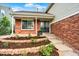 Welcoming front entry with double doors, brick accents, landscaped garden beds and a cozy, covered porch at 2246 Mountain Sage Dr, Highlands Ranch, CO 80126