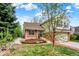 Charming two-story home with a beautiful garden, lawn, and brick walkway at 2246 Mountain Sage Dr, Highlands Ranch, CO 80126