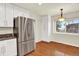 Eat-in kitchen offers granite countertops, stainless steel refrigerator and an abundance of natural light at 2246 Mountain Sage Dr, Highlands Ranch, CO 80126
