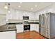 Modern kitchen with stainless steel appliances, granite countertops, and ample white cabinetry for storage at 2246 Mountain Sage Dr, Highlands Ranch, CO 80126