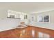 Bright living room with hardwood floors, ample natural light, and easy access to the kitchen and outdoor areas at 2246 Mountain Sage Dr, Highlands Ranch, CO 80126