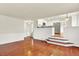 Open concept living room with wood floors that flow into the kitchen and dining area, perfect for entertaining at 2246 Mountain Sage Dr, Highlands Ranch, CO 80126