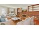 Cozy living room boasts a brick fireplace with built-in shelves, plush seating, and lots of natural light at 2246 Mountain Sage Dr, Highlands Ranch, CO 80126