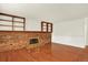 Spacious living room features a brick fireplace, wood flooring, and built-in shelving for a cozy gathering space at 2246 Mountain Sage Dr, Highlands Ranch, CO 80126