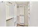 Walk-in closet featuring white shelving, rods, and drawers at 2246 Mountain Sage Dr, Highlands Ranch, CO 80126