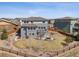 Aerial view of home and landscaped backyard featuring a stone patio, trampoline, and wood fence at 11426 Box Turtle Ct, Parker, CO 80134