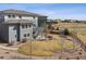 Aerial view of home and large backyard with a stone patio, trampoline, and wood fence at 11426 Box Turtle Ct, Parker, CO 80134