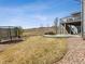 Spacious backyard with trampoline, a stone patio with a firepit, and access to a second story deck at 11426 Box Turtle Ct, Parker, CO 80134