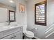 A charming bathroom with a marble countertop, gray vanity, and window shutters at 11426 Box Turtle Ct, Parker, CO 80134