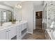 Modern bathroom featuring a double vanity, walk-in closet, and a glass enclosed shower with a soaking tub at 11426 Box Turtle Ct, Parker, CO 80134
