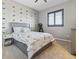 Charming bedroom featuring a dinosaur-themed decor, a comfortable bed, and a window with natural light at 11426 Box Turtle Ct, Parker, CO 80134