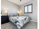 Bright bedroom featuring a comfortable bed, a window with natural light, and a black dresser at 11426 Box Turtle Ct, Parker, CO 80134